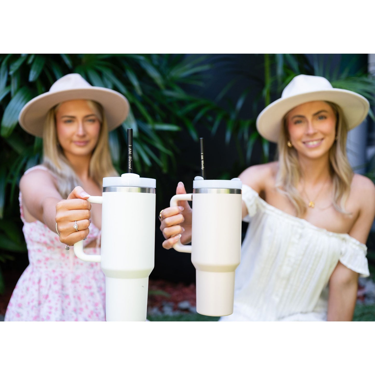 Women using I AM WORTHY reusable affirmation straws in large water bottles